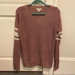Pink sweater with stripes at elbows